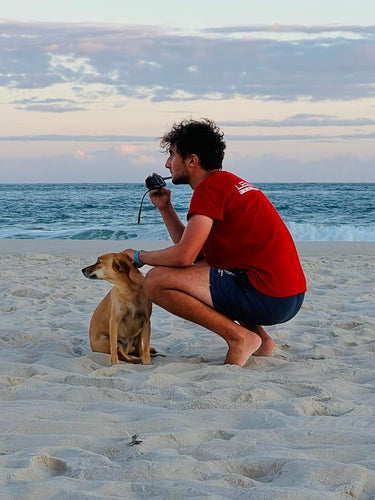 man on beach with dog