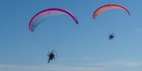 two parajets flying in the sky