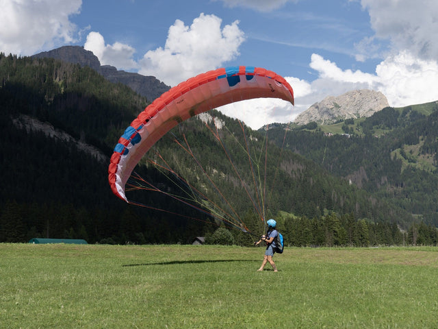 person holding flying paramotor wing