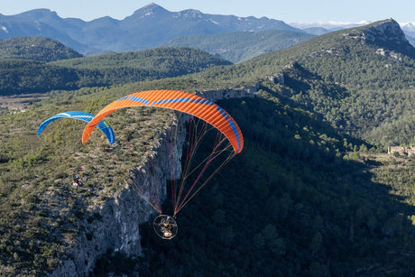 two parajets flying over a cliff